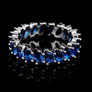 Macro view of eternity ring featuring oval-cut blue sapphires in silver setting
