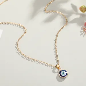 Elegant gold evil eye pendant necklace with blue enamel charm on minimalist chain