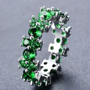 Macro-opname van zilveren ring met rondom gezette groene zirkonia in briljantslijpsel