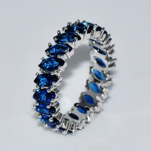 Eternity ring with marquise cut blue zircon stones in silver tone setting