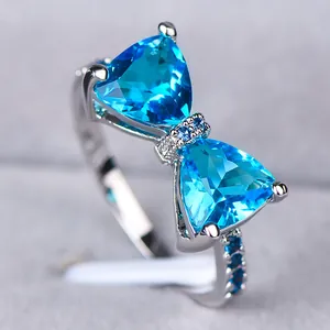 Macro-opname van strikring met blauwe edelstenen en pavé-gezette zirkonia