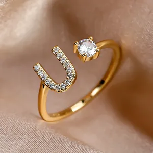 Adjustable gold letter U ring with sparkling zircon stones and round crystal centerpiece