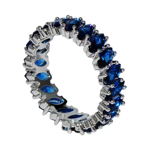 Eternity ring featuring marquise-cut sapphire blue stones in a silver prong setting