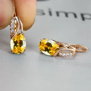Oval yellow crystal zircon earrings in rose gold finish with small white diamonds
