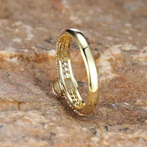 Golden oval opal ring with side diamond setting on a natural rock display