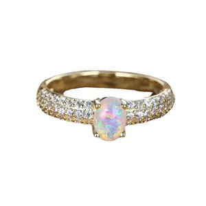 Elegant gold vintage ring with oval white opal stone and pavé set cubic zirconia accents