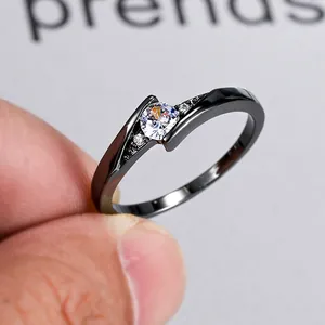 Classic black gold plated ring featuring a central round zircon and twisted pave setting