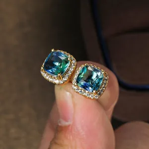 Detailed close-up of a square cushion-cut gradient tourmaline stud earring with halo diamonds