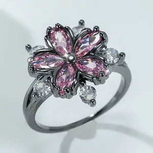 Pink zircon flower ring with black metal plating and sparkling white accents