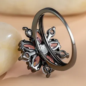 Pink zircon flower ring in black metal finish featuring cherry blossom petal design