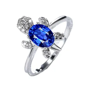 Silver turtle ring featuring a large oval blue gemstone shell and sparkling zircon accents