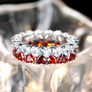 Macro shot of double-row heart-shaped zircon ring with red and white gemstones