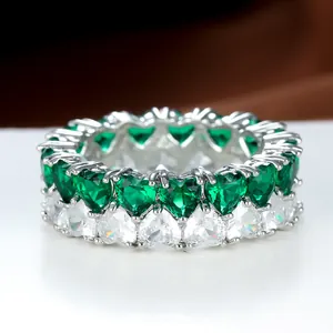 Detail of eternity band with double row heart-cut green and white cubic zirconia stones