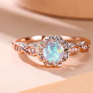 Macro shot of rose gold opal ring featuring intricate lace-like diamond halo detailing