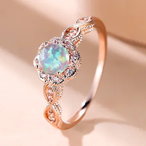 Macro detail of round white opal flower ring with intricate lace style rose gold band