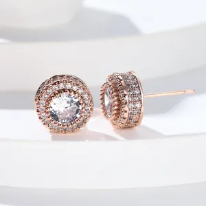Close-up of rose gold micro-paved cubic zirconia round stud earrings with halo design