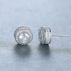 Macro detail of silver round halo stud earrings with micro-paved cubic zirconia stones