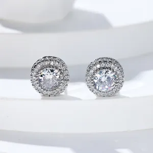 Close-up of halo stud earrings with silver metal and double-row micro-pave zirconia crystals