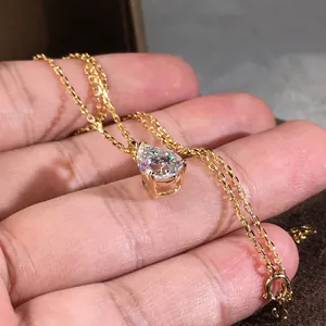 Elegant gold pear cut cubic zirconia teardrop pendant necklace for women shown in hand