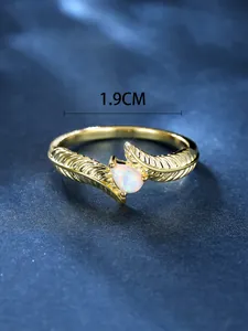 Detail showing the 1.9cm inner diameter of the golden teardrop opal feather ring