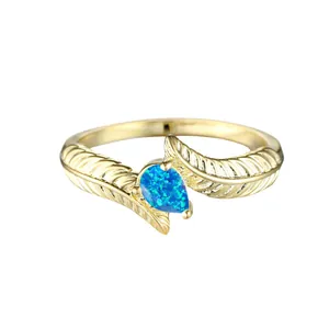 Elegant golden double feather ring with pear-shaped blue opal teardrop stone inlay