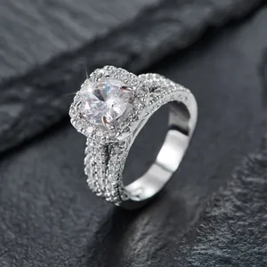 Quadratischer Halo-Ring aus Platin mit rundem Stein und geteiltem Pavé-Band auf Stein