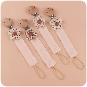 Set of 4 beechwood pacifier clips with pink cotton fabric straps and floral patterns