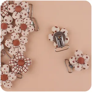 Detail of floral printed fabric baby pacifier clips with stainless steel metal backing
