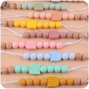 Attache-tétine en silicone arc-en-ciel et bois de hêtre en divers coloris macaron
