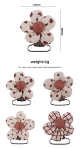 Detailed view of floral fabric pacifier clips in heart and polka dot prints with dimensions