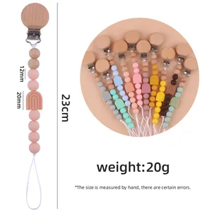 Attache-tétine arc-en-ciel en silicone avec clip en hêtre aux couleurs douces Morandi