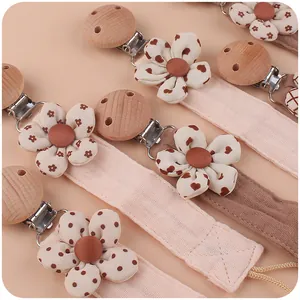 Handmade beech wood pacifier clips with floral cotton straps for infant soothing