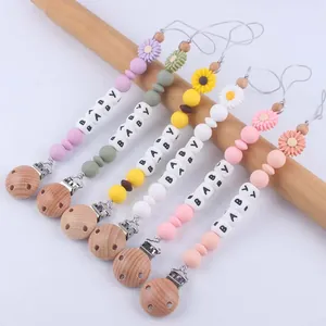 Silicone daisy pacifier clips with wooden clasps and baby beads in various colors