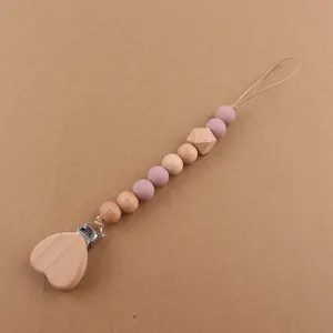 Detail of wooden heart clip and silicone beads for baby pacifier chain accessory