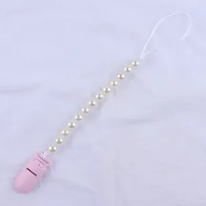 Pink and off-white baby pacifier clip with twelve faux pearls and plastic duckbill clip