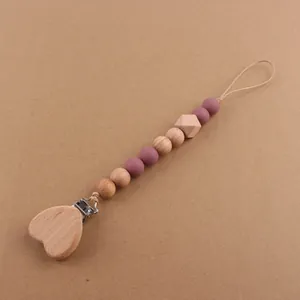 Detail of wooden heart clip and silicone beads on a handmade baby pacifier chain