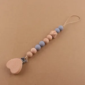Detailed view of heart beech wood clip and silicone beads for baby pacifier chain