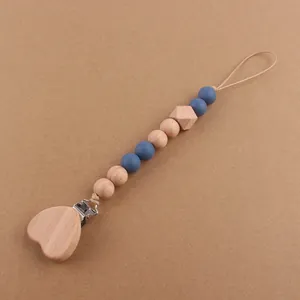 Detail of wooden heart clip with silicone and beechwood beads for pacifier chain