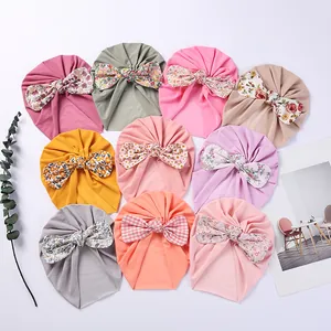 Set of ten colorful baby turban hats with large floral and plaid bow decorations