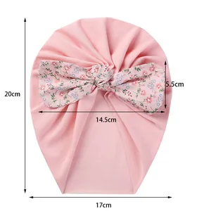 Detail view of pink baby turban hat showing 20x17cm dimensions and floral bow size
