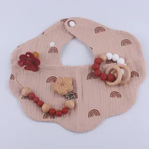 Baby teething set with rainbow gauze bib, flower pacifier clip, and silicone wooden ring
