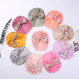 Set of 10 colorful baby turban hats with decorative bows in floral and polka dot patterns