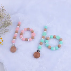 Baby silicone pacifier clip with rose teething beads and wood ring set in pink and green