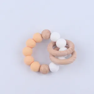 Macro detail of silicone beads and natural beech wood rings for infant teething relief