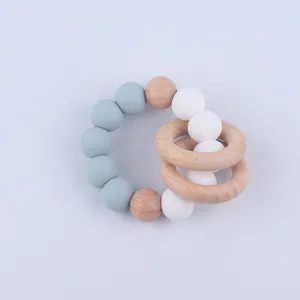 Close-up of silicone beads and natural beech wood rings on baby teething bracelet
