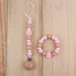 Pink silicone and wood teething toy set with rose flower beads and pacifier clip