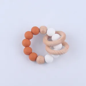Detailed view of silicone beads and natural beech wood rings for infant teething relief