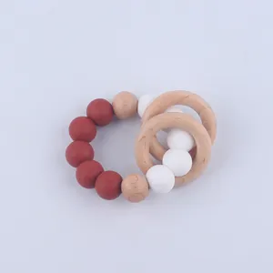 Detail of red and white silicone beads with dual natural beech wood rings for baby teething