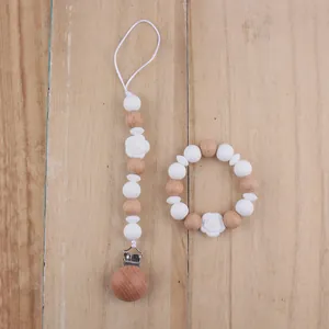 Detailed set of white silicone beads and wooden baby pacifier clip with flower pendant