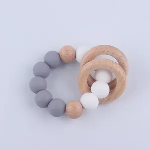 Detail of baby teething bracelet with grey silicone beads and natural beech wood rings